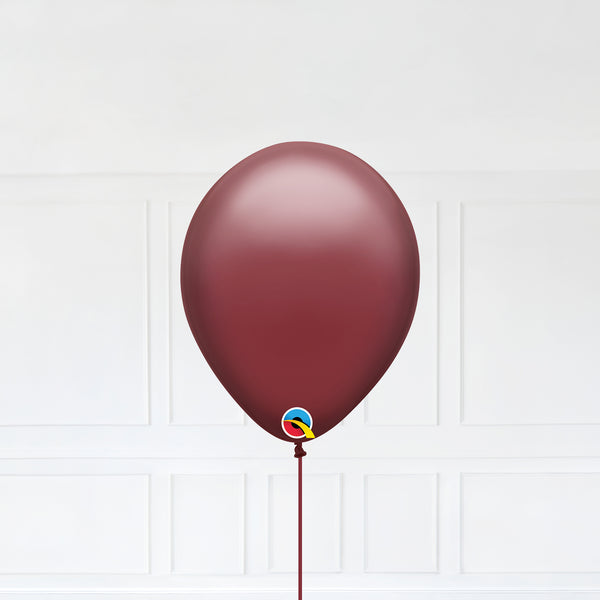 Cranberry color Latex balloon inflated with helium and a matching with 1.5 meter ribbon