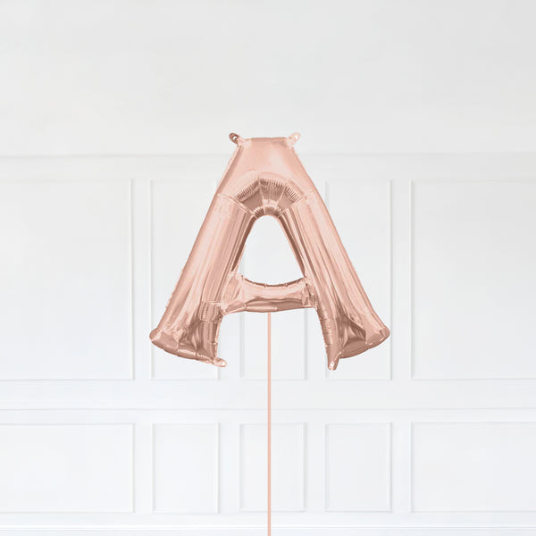 Letter A Foil Balloon Inflated With Helium, Rose Gold Color Letter A with Balloon String and Balloon Weight.