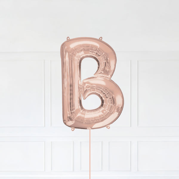 Letter B Foil Balloon Inflated With Helium, Rose Gold Color Letter B with Balloon String and Balloon Weight.