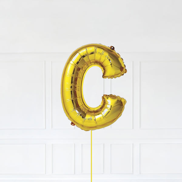 Letter C Foil Balloon Inflated With Helium, Gold Color Letter C with Balloon String and Balloon Weight.