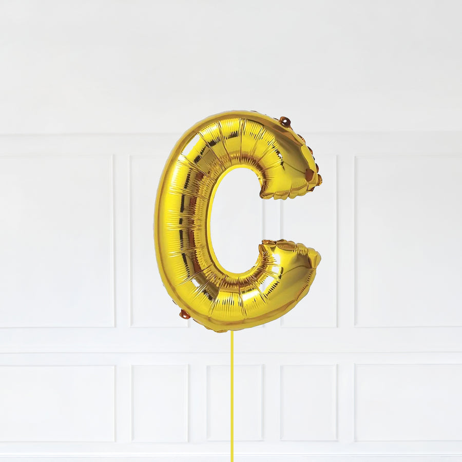 Letter C Foil Balloon Inflated With Helium, Gold Color Letter C with Balloon String and Balloon Weight.