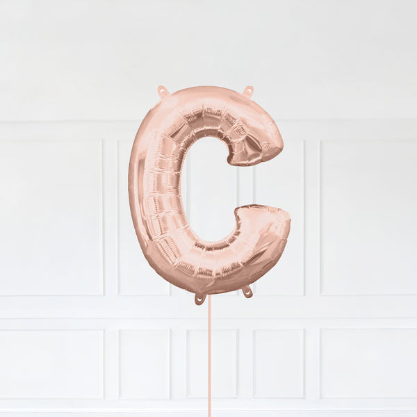 Letter C Foil Balloon Inflated With Helium, Rose Gold Color Letter C with Balloon String and Balloon Weight.