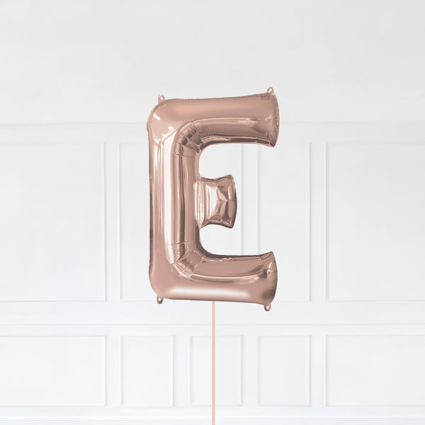 Letter E Foil Balloon Inflated With Helium, Rose Gold Color Letter E with Balloon String and Balloon Weight.