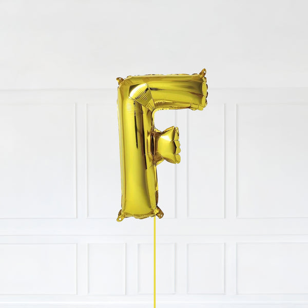 Letter F Foil Balloon Inflated With Helium, Gold Color Letter F with Balloon String and Balloon Weight.