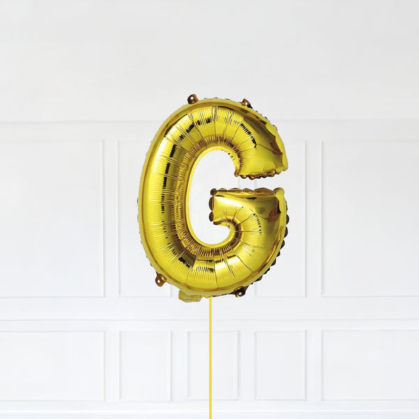 Letter G Foil Balloon Inflated With Helium, Gold Color Letter G with Balloon String and Balloon Weight.