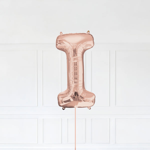 Letter I Foil Balloon Inflated With Helium, Rose Gold Color Letter I with Balloon String and Balloon Weight.