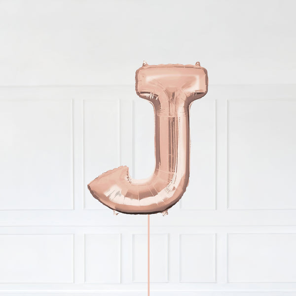 Letter J Foil Balloon Inflated With Helium, Rose Gold Color Letter J with Balloon String and Balloon Weight.