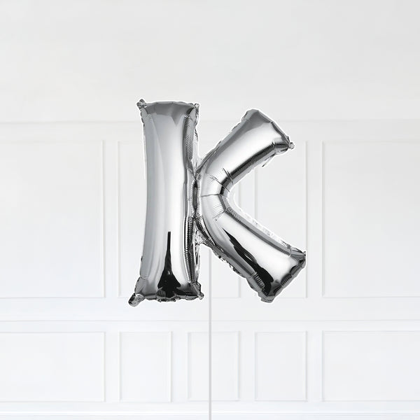 Letter K Foil Balloon Inflated With Helium, Silver Color Letter K with Balloon String and Balloon Weight.