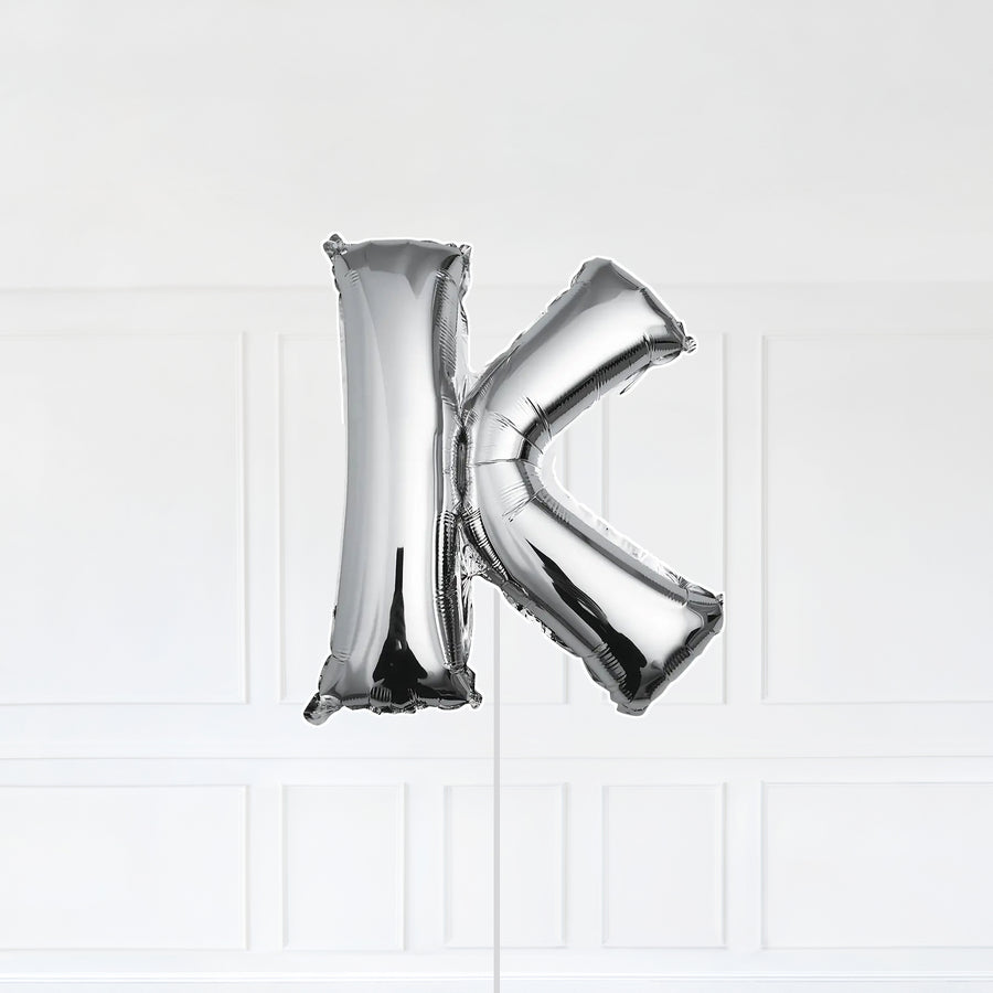 Letter K Foil Balloon Inflated With Helium, Silver Color Letter K with Balloon String and Balloon Weight.
