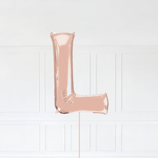 Letter L Foil Balloon Inflated With Helium, Rose Gold Color Letter L with Balloon String and Balloon Weight.