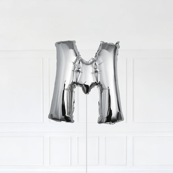 Letter M Foil Balloon Inflated With Helium, Silver Color Letter M with Balloon String and Balloon Weight.