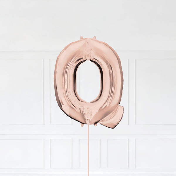 Letter Q Foil Balloon Inflated With Helium, Rose Gold Color Letter Q with Balloon String and Balloon Weight.