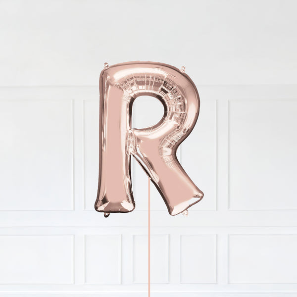 Letter R Foil Balloon Inflated With Helium, Rose Gold Color Letter R with Balloon String and Balloon Weight.