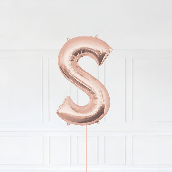 Letter S Foil Balloon Inflated With Helium, Rose Gold Color Letter S with Balloon String and Balloon Weight.