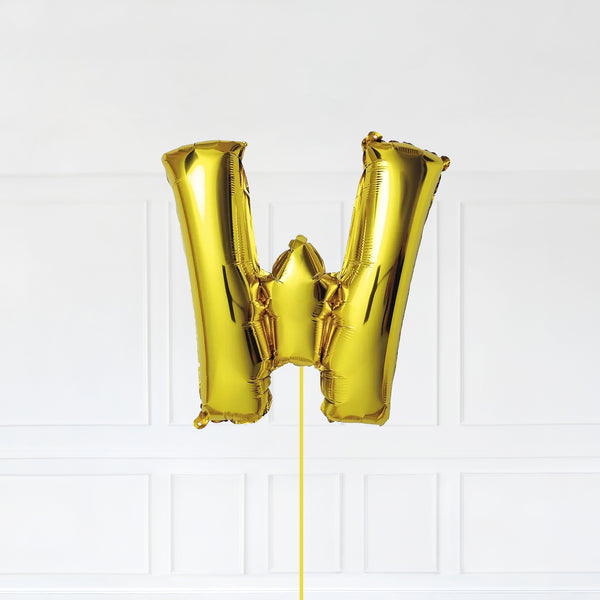 Letter W Foil Balloon Inflated With Helium, Gold Color Letter W with Balloon String and Balloon Weight.