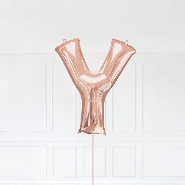 Letter Y Foil Balloon Inflated With Helium, Rose Gold Color Letter Y with Balloon String and Balloon Weight.