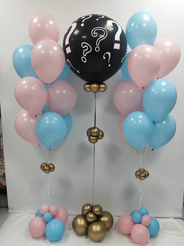 gender reveal helium balloons with pastel pink and blue balloons